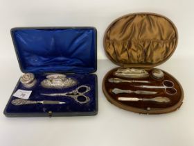 Two cased silver manicure sets.