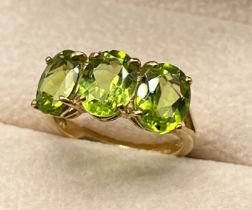9ct yellow gold ring set with three oval cut green tourmaline stones. [Ring size N] [3.58Grams]