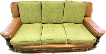 Vintage three seat settee, the high back with green upholstered cushions above out swept arms and