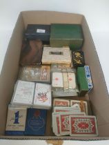 A large collection of antique playing cards mostly boxed