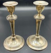 A Pair of Sheffield silver weighted candle sticks. Produced by James Deakin & Sons. [21cm high]