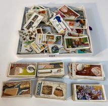 A collection of wills cigarette wild flowers & tree cards along with wills cigarette household