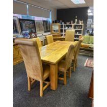 Contemporary oak table together with six chairs and footstool upholstered in a tan leather