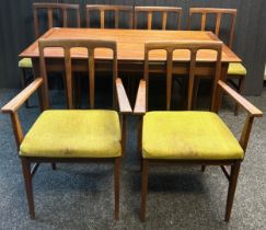 Mid century teak extending dining table together with two arm chairs and four additional chairs