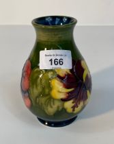 A Moorcroft 'Hibiscus' pattern vase in green background [13.5cm]