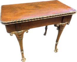 19th century mahogany flip top table, raised on carved scroll legs ending in claw and ball feet [