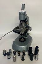 A Vintage microscope with a collection of spare lenses