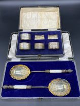 Boxed set of four Birmingham silver napkin rings. Together with a pair of Silver plate and mother of