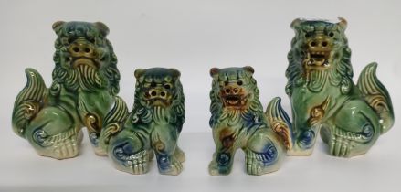 A collection of four Chinese drip glazed Foo dog figures [14cm]