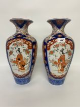 A pair of 20th century Japanese Imari pattern vases, decorated with four pictorial panels