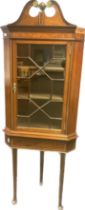 Antique mahogany and walnut display unit, the glazed astragal door opening to shelved interior,