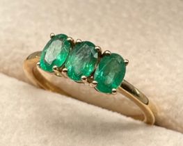 10ct yellow gold ring set with three oval cut emerald gem stones. [Ring size P] [2.39Grams]