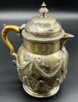 London silver ornate raised relief cream pot, Wrapped silver and wicker handle. Produced by