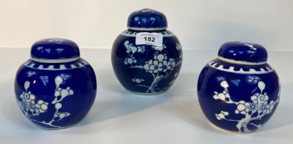 A collection of 3 Chinese lidded prunes ginger jars with covers set in blue background design with