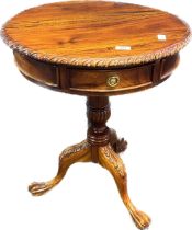 Reproduction mahogany drum table, the circular top with pie crust edging, raised on a tripod base