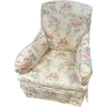Antique armchair, re-covered in a floral upholstery, raised on turned legs ending in brass castors