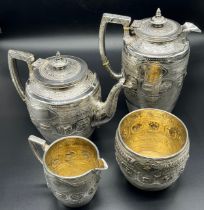 A Highly decorative E.P.N.S four piece tea/ coffee service. Engraved trims and raised relief