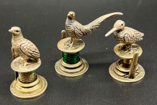 Three various London silver figural bird menu/ card holders. Produced by Goldsmiths & Silversmiths