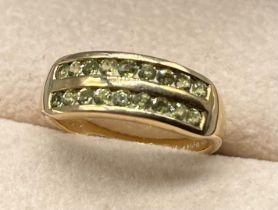 9ct yellow gold ring set with a cluster of round cut green gem stones, two rows. [Ring size N] [2.