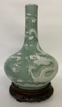 A CHINESE CELADON-GLAZED SLIP-DECORATED 'DRAGON' VASE. Qing Dynasty, 19th Century. Decorated with