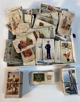 A collection of players military & steam engine cigarette cards