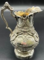 Highly decorative Victorian London silver cream jug. Raised angel figures, wreathes and foliage. [