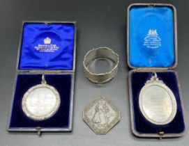 A Selection of medallions and silver napkin ring; Two Boxed silver presentation medallions/