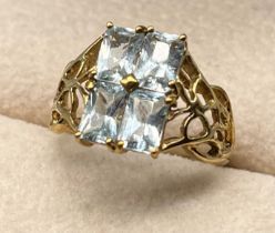 9ct yellow gold ring set with four blue gem stones. [Ring size N] [2.67Grams]