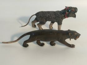 A 19th century Carved tiger rhino horn figure along with a white metal jewelled tiger figure [20cm]