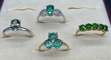 Four 10ct white and gold rings, fitted with various Gem stones; Emeralds and Iolite. [8.54grams]