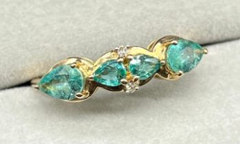 10ct yellow gold ring set with four pear drop cut Emerald stones and two round cut diamonds. [Ring