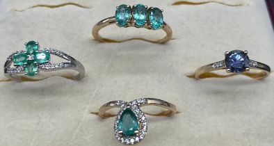 Four 10ct yellow and white gold rings. All with various gem stones. [8.36grams]