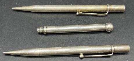 Three antique silver revolving pencils.