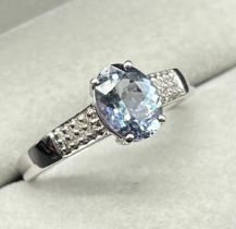 10ct white gold ring set with a blue Iolite gem stone and diamond shoulders. [Ring size P] [2.