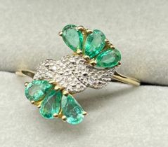 10ct yellow gold ring set with six emerald gem stones and diamonds stones. [Ring size P] [2.40Grams]