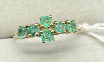 10ct yellow gold ring set with six round cut emerald gem stones. [Ring size P] [1.98Grams]