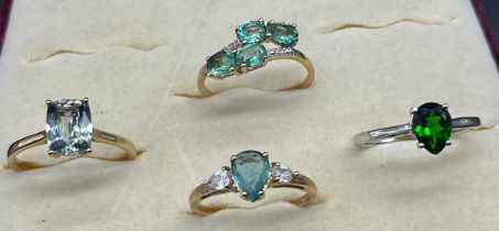 Four various 10ct yellow and white gold rings fitted with various gem stones. [7.59grams]