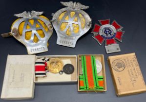 Two boxed Military medals together with three various car badges; The Order of the Road enamel car