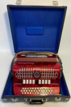 A Paolo Soprani button accordian in fitted case [40x40cm]