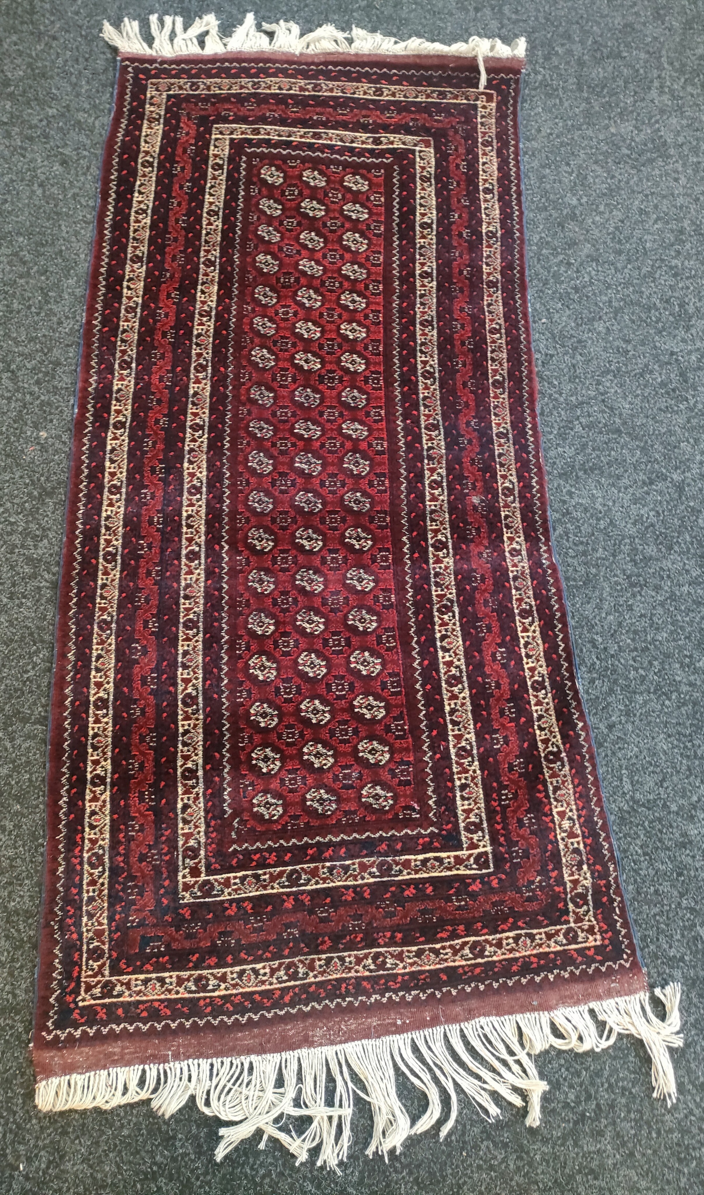 An Afghan hand woven rug [186x85cm]