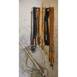 A collection of antique fly fishing rods with bags & fishing net; Greys of Alnwick fly rod & Cain