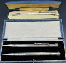 Three boxed silver pencils; Yard O Led London silver revolving pencil and two matching London silver