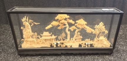 Chinese cork carving diorama within a black glass case.