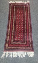 An Afghan hand woven rug [202x86cm]