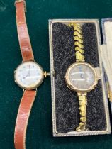 Two 9ct gold cased watches. One with a leather strap the other with a gilt plated elasticated strap.