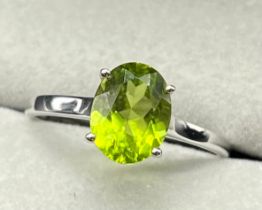 10ct white gold ring set with an oval cut green tourmaline gem stone. [Ring size P] [1.73Grams]