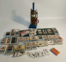 A vintage steam donkey engine together with a large collection of cigarette cards including