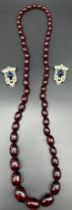 Vintage graduating Cherry amber bead necklace. Together with a pair of art deco clip on earrings. [