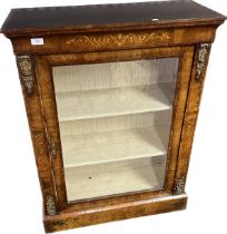 Victorian display cabinet with marquetery frieze above a glazed door opening to shelved interior,
