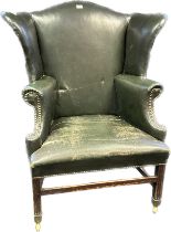 19th Century gullwing armchair, the whole covered in a green leather upholstery with brass nail head